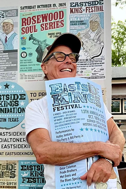 Man hugging poster for the East Side Kings Festival